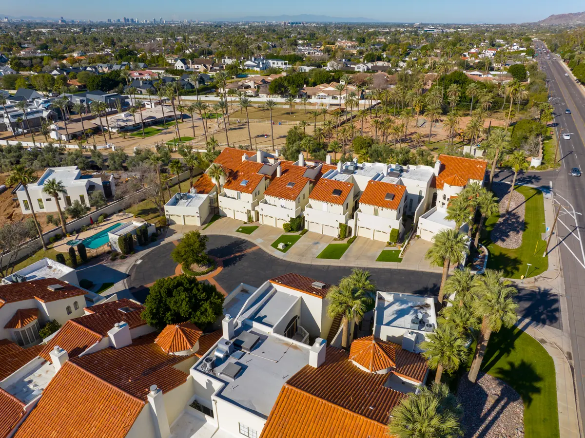 Aerial view of Valley homes with tile roofs, backyard pools and palm trees